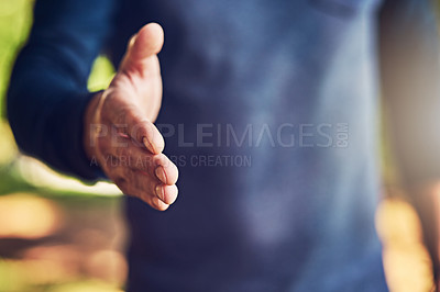 Buy stock photo Closeup shot of an unrecognizable man extending a handshake outdoors