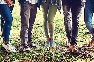Buy stock photo Closeup shot of an unrecognizable group of friends standing together outdoors