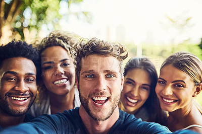 Buy stock photo Portrait of a group of friends taking a selfie together outdoors