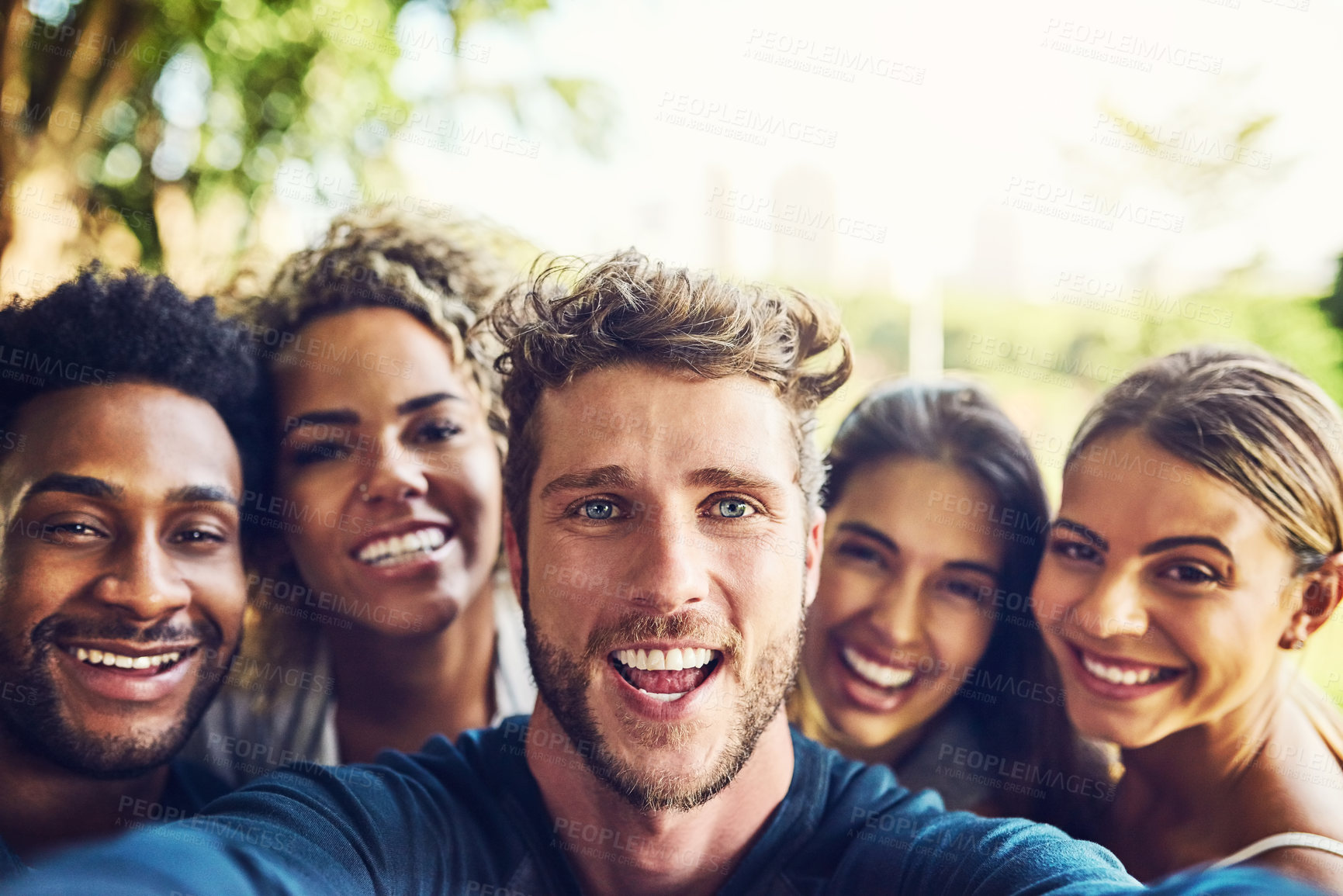 Buy stock photo Portrait of a group of friends taking a selfie together outdoors