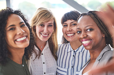 Buy stock photo Cropped shot of a group businesswomen taking a selfie together in the office