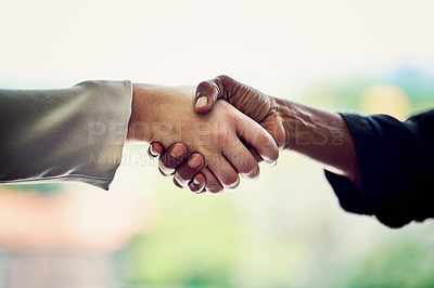 Buy stock photo Cropped shot of unrecognizable businesswomen shaking hands in the office