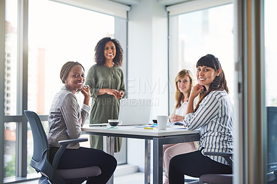 Buy stock photo Cropped shot of a group of businesswomen having a meeting in the office