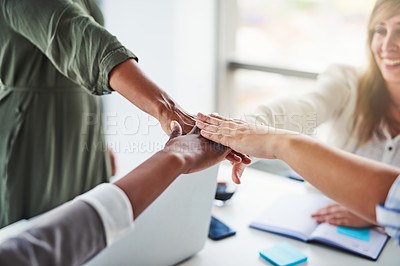 Buy stock photo Cropped shot of unrecognizable businesswomen piling their hands on top of each other in the office