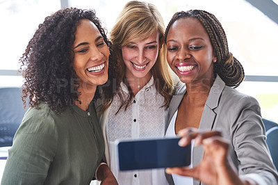 Buy stock photo Cropped shot of a group of  businesswomen taking a selfie in the office