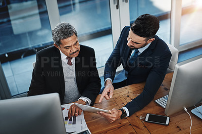 Buy stock photo High angle shot of colleagues working together in a modern office