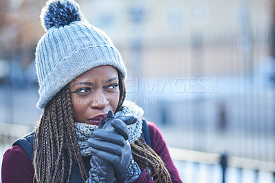 Buy stock photo Shot of a beautiful young woman looking thoughtful on a wintery day outdoors