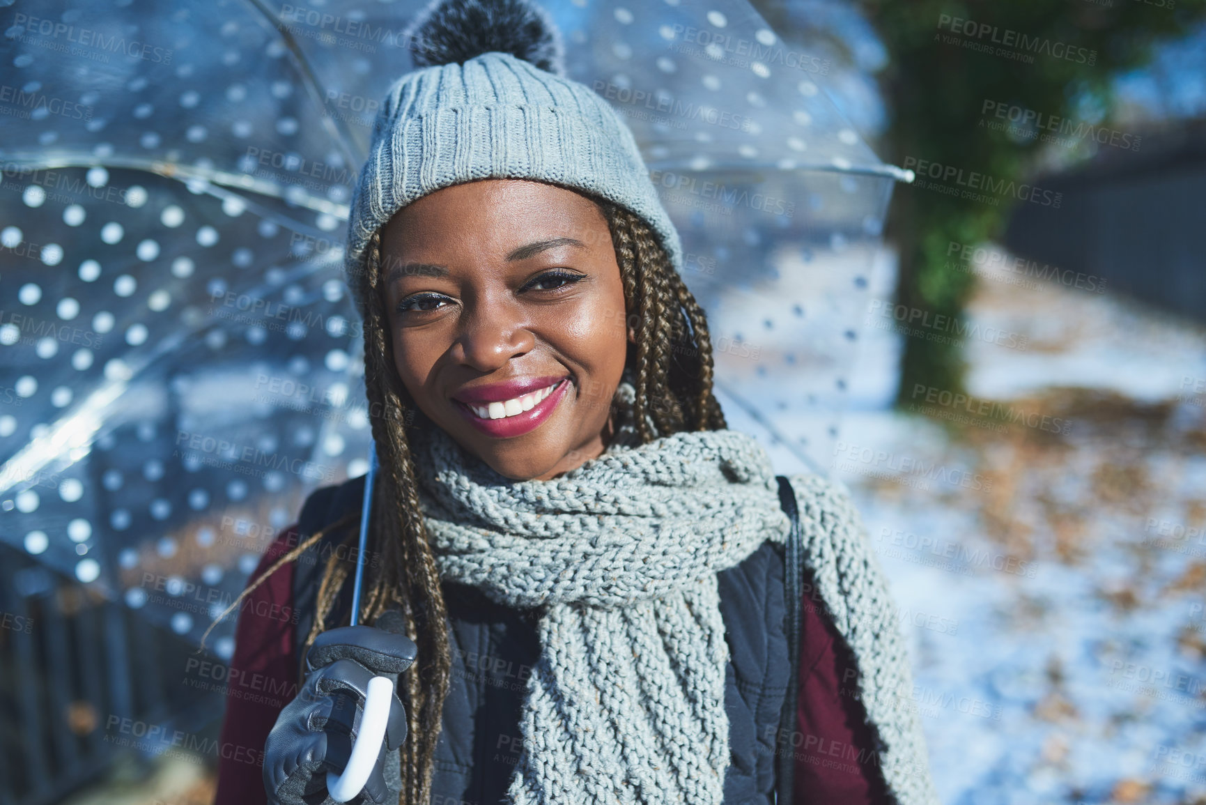 Buy stock photo Shot of a beautiful young woman holding an umbrella on a wintery day outdoors