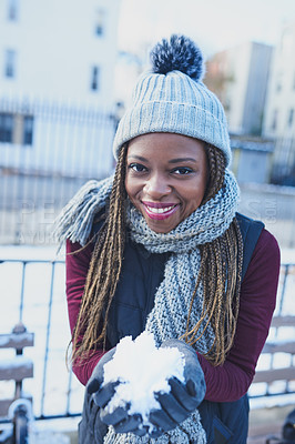 Buy stock photo Shot of a beautiful young woman holding a snowball on a wintery day outdoors