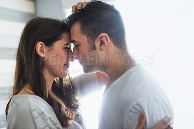 Buy stock photo Home, couple and kiss with love for affection with bonding, support and care as lovers. People, profile and smile or happy with relationship on break to relax, rest and chill at apartment with trust