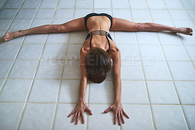 Buy stock photo Full length shot of an attractive young female athlete working out at home