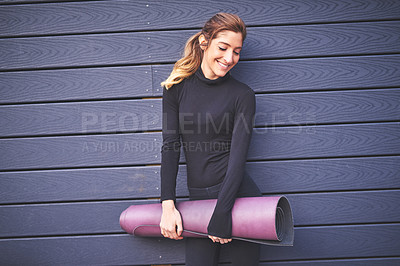 Buy stock photo Cropped shot of an attractive young female athlete carrying her yoga mat