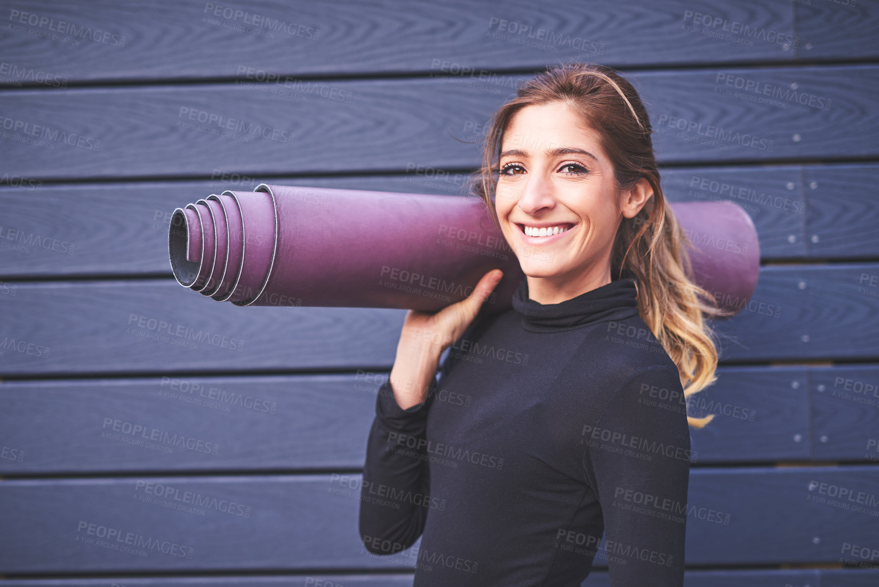 Buy stock photo Cropped portrait of an attractive young female athlete carrying her yoga mat