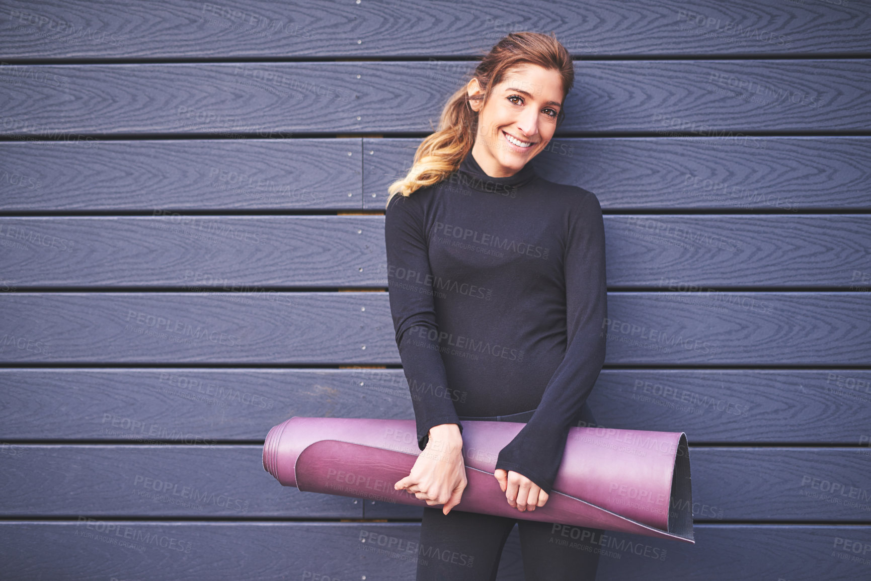 Buy stock photo Cropped portrait of an attractive young female athlete carrying her yoga mat