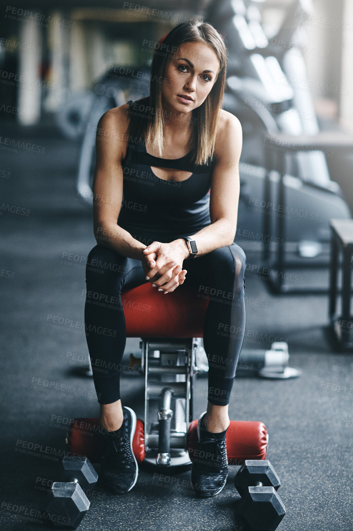 Buy stock photo Portrait of an attractive young woman working out in the gym