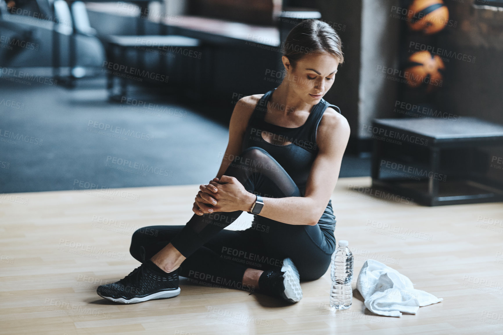 Buy stock photo Shot of an attractive young woman working out in the gym