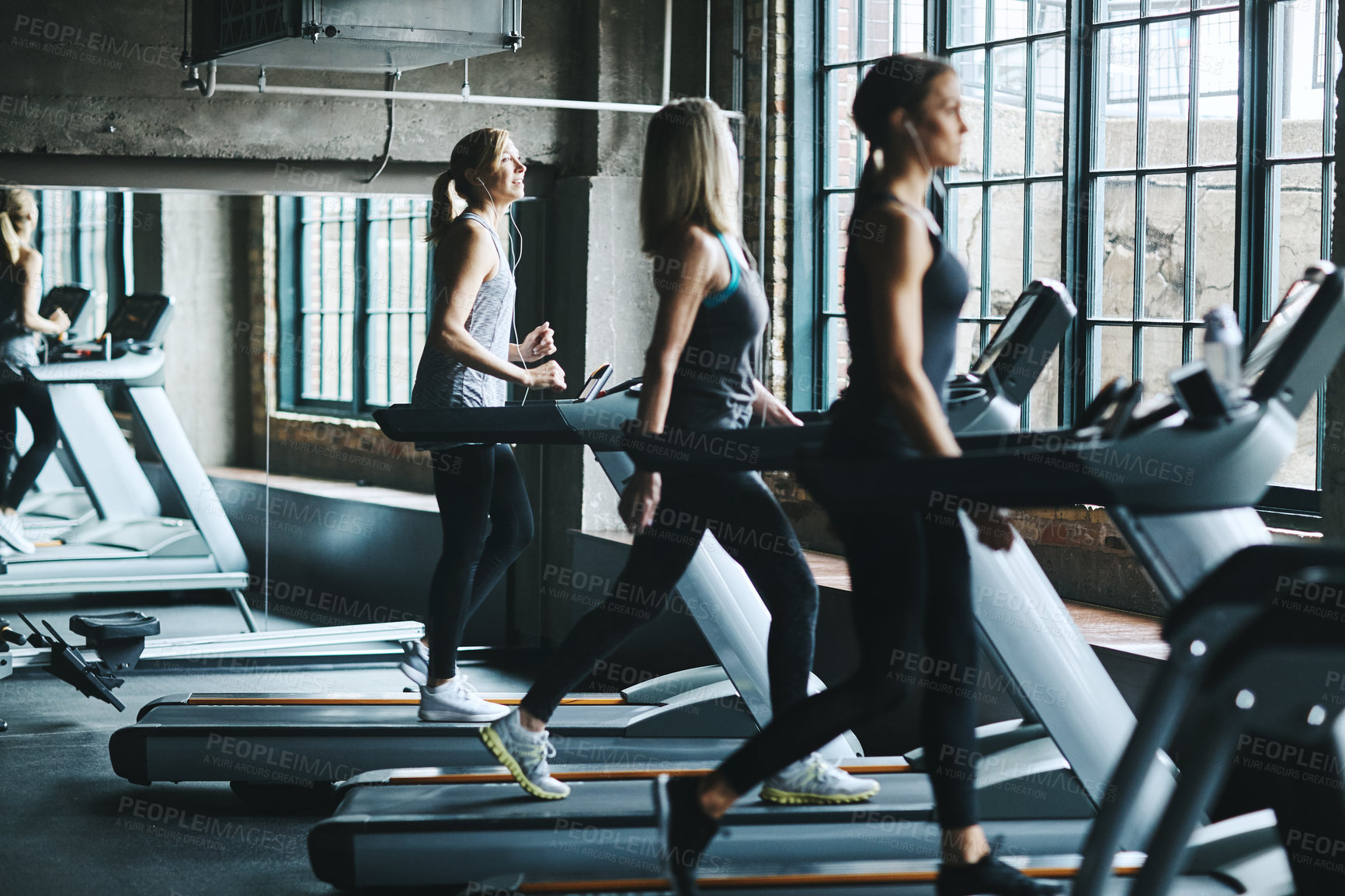 Buy stock photo Shot of women working out in the gym