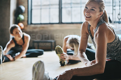Buy stock photo Fitness, gym and women stretching, training and exercise for wellness, healthy lifestyle and balance. Female people, athletes and happy girls on the floor, stretch legs and workout goals with practice