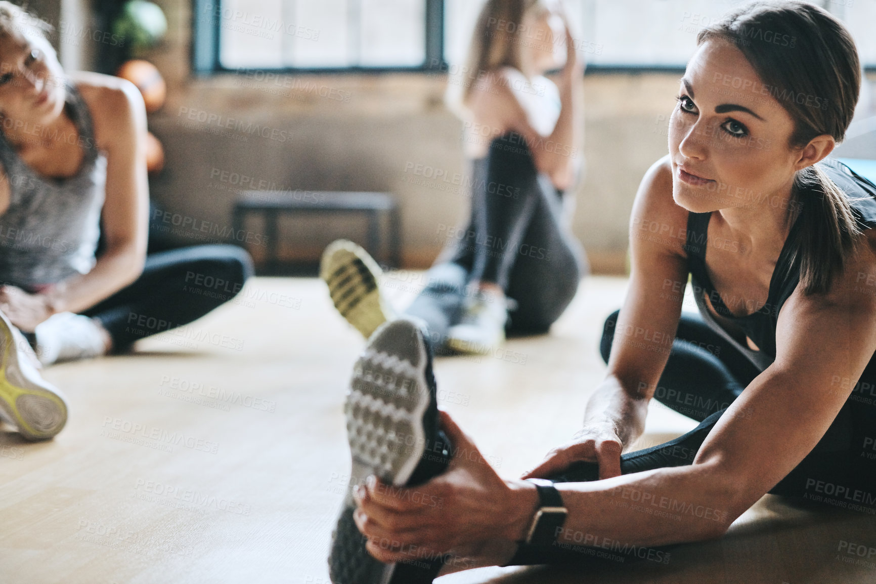 Buy stock photo Women, coach and stretching legs on gym floor, together and guide for training, fitness and health. People, friends and class with support, club and warm up for exercise, workout and wellness