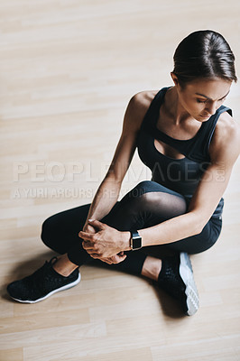 Buy stock photo High angle shot of an attractive young woman working out in the gym
