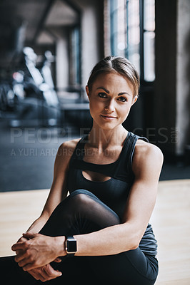 Buy stock photo Cropped portrait of an attractive young woman working out in the gym
