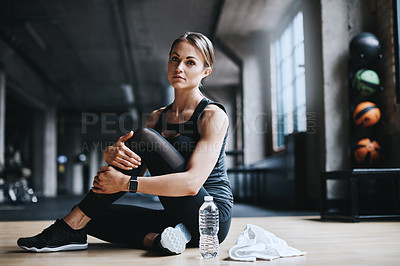Buy stock photo Full length shot of an attractive young woman working out in the gym