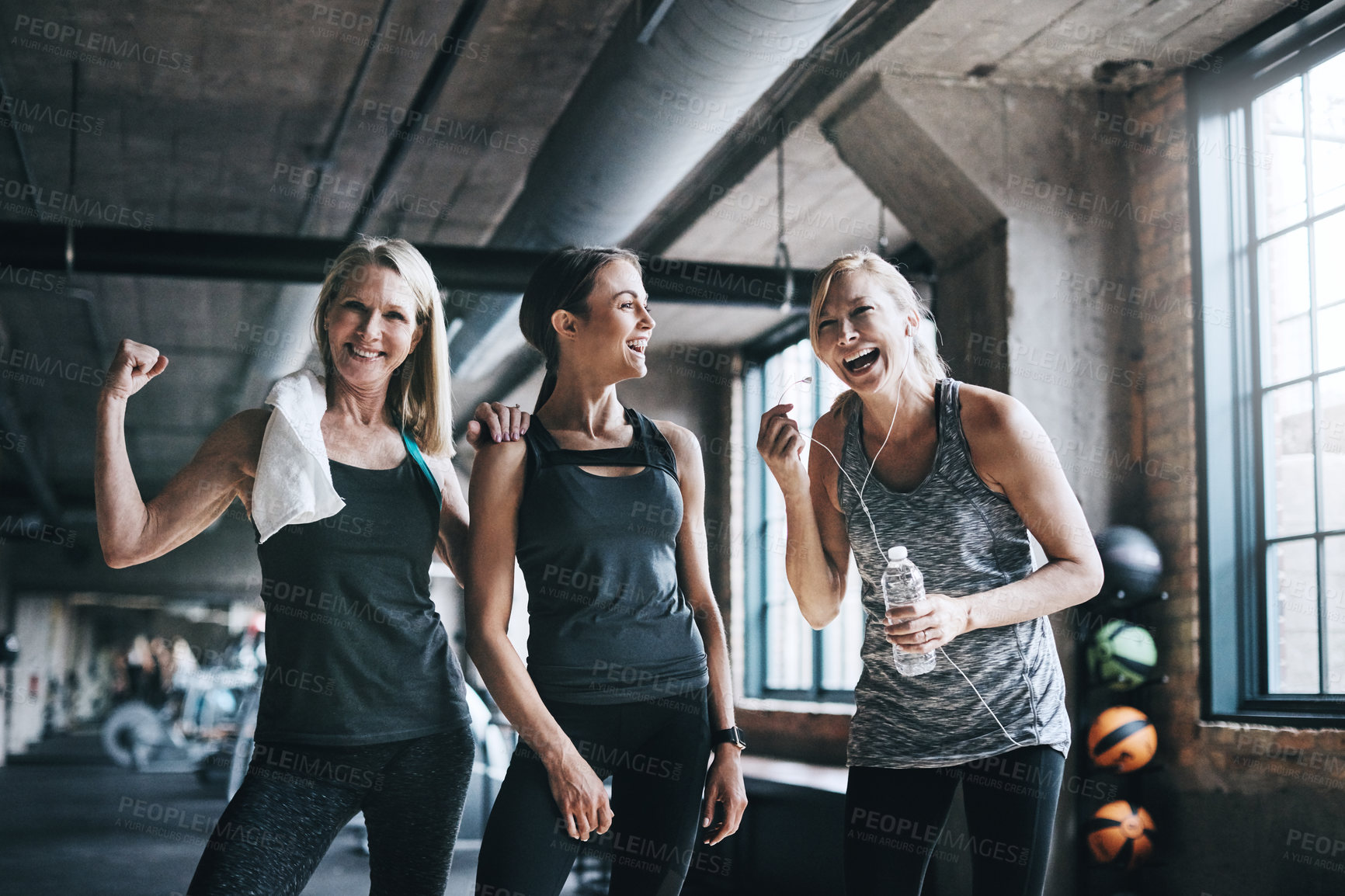 Buy stock photo Cropped portrait of three attractive and athletic women working out in the gym