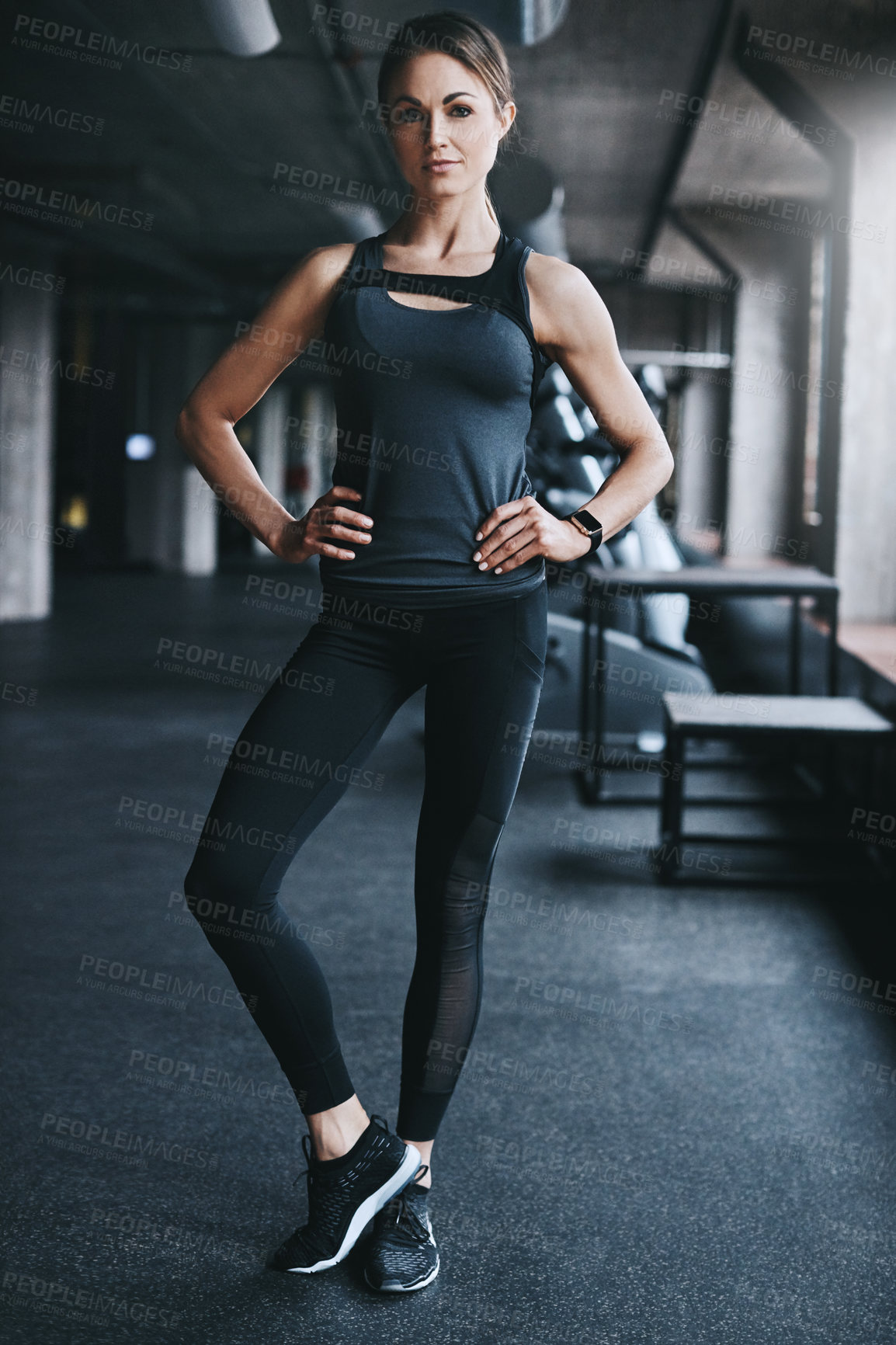 Buy stock photo Full length portrait of an attractive young woman standing with her hands on her hips in the gym