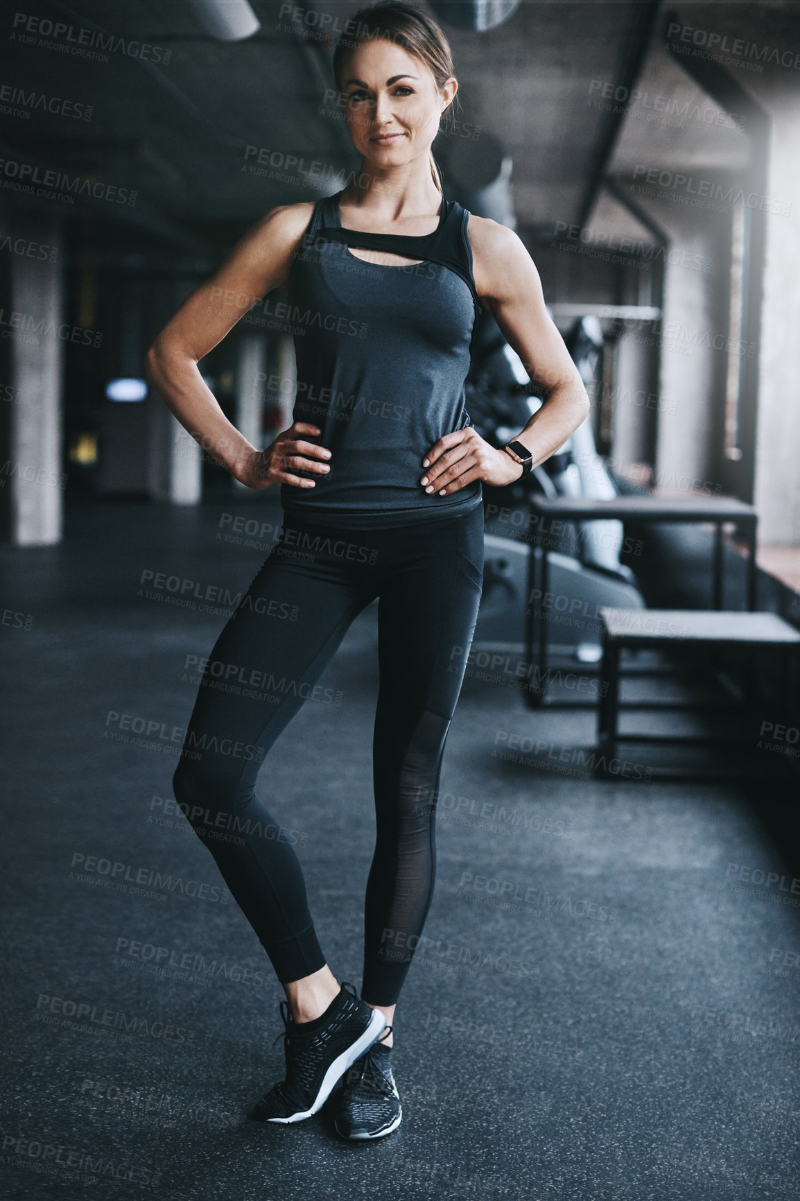 Buy stock photo Full length portrait of an attractive young woman standing with her hands on her hips in the gym