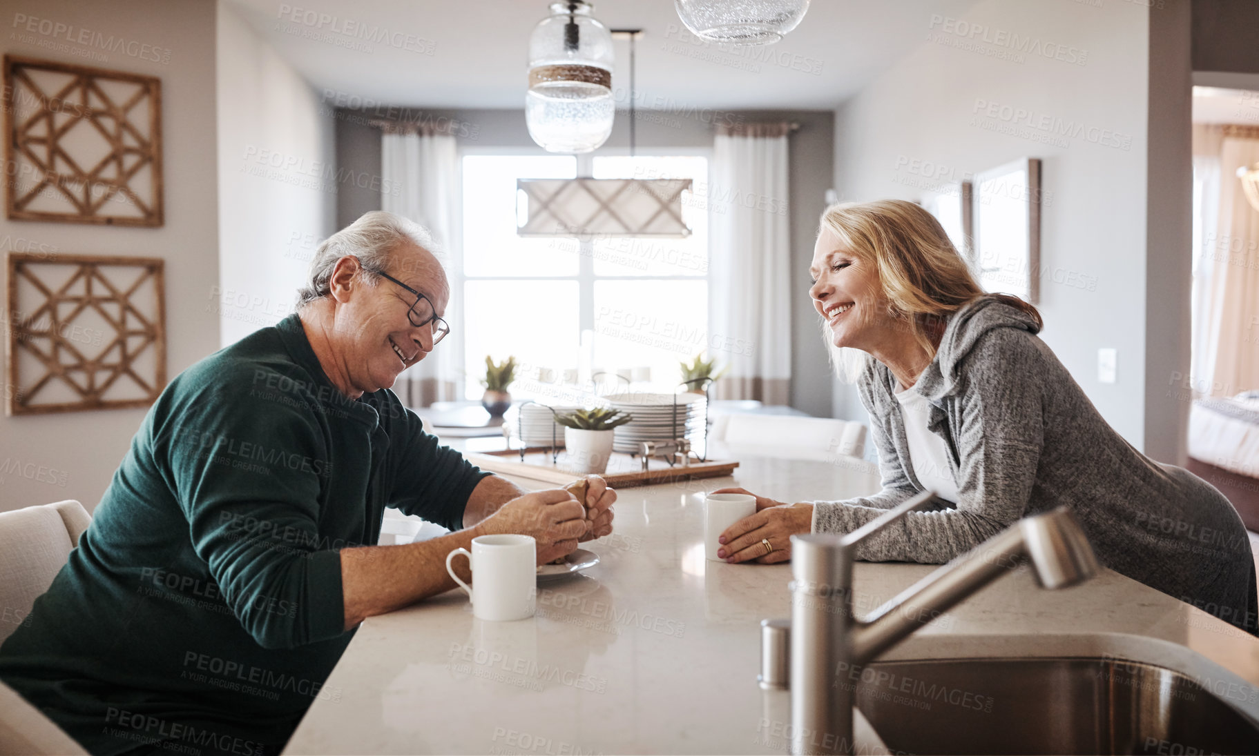 Buy stock photo Shot of a mature couple having coffee and a snack during a relaxed day at home