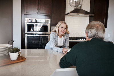 Buy stock photo Shot of a mature couple having coffee and a conversation during a relaxed day at home