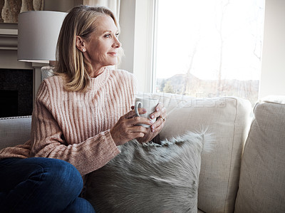 Buy stock photo Mature woman, coffee and couch by window with smile for thinking, memory and insight in home. Person, tea cup and relax on sofa in lounge, remember and reflection with nostalgia at house in Croatia