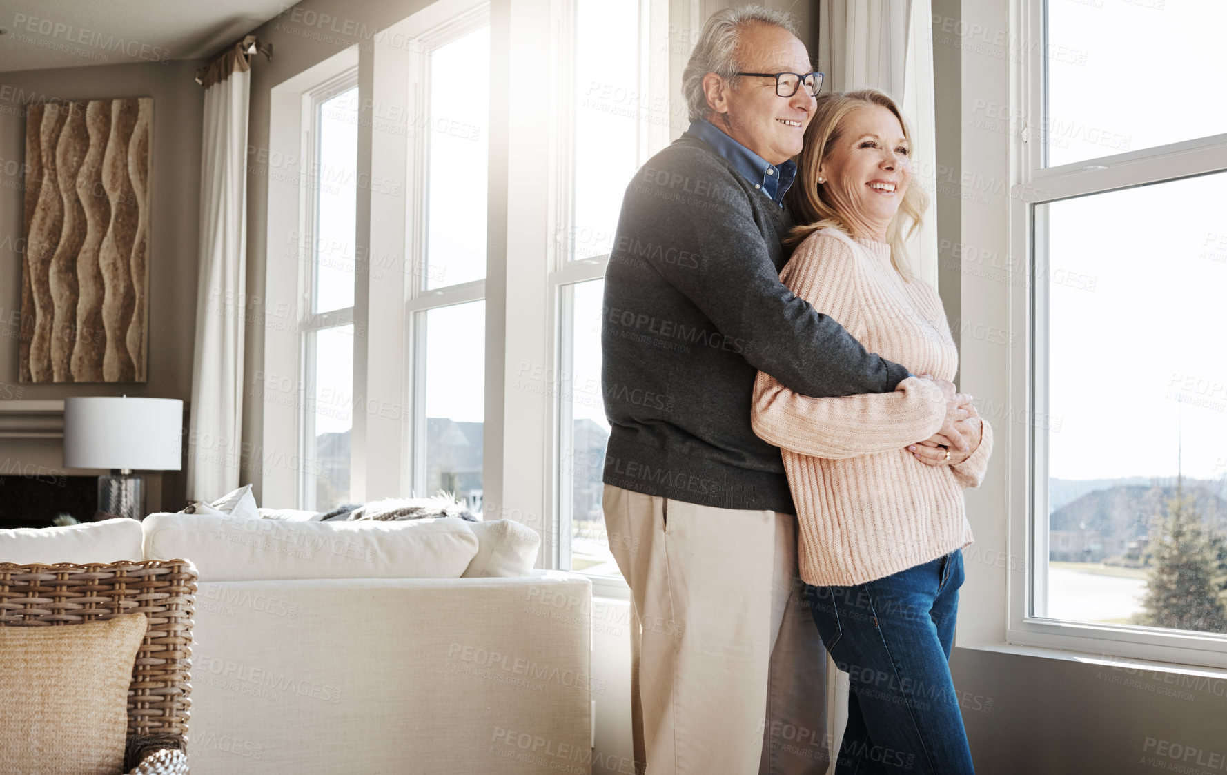 Buy stock photo Shot of a loving mature couple relaxing together at home