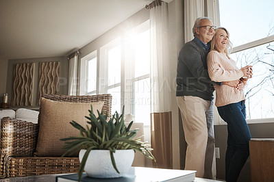 Buy stock photo Shot of a loving mature couple relaxing together at home