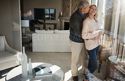 Buy stock photo Shot of a loving mature couple relaxing together at home