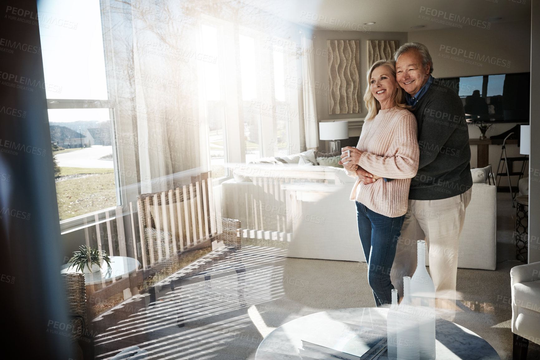 Buy stock photo Shot of a loving mature couple relaxing together at home