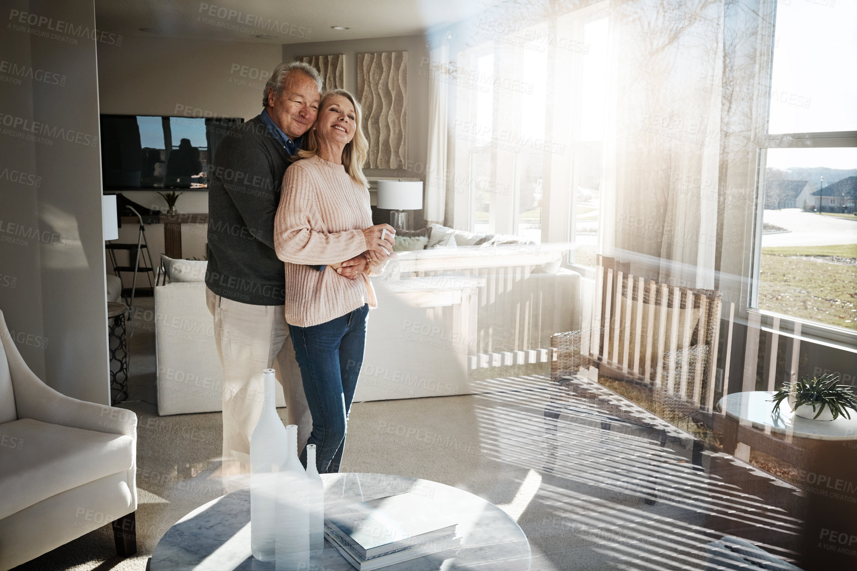 Buy stock photo Shot of a loving mature couple relaxing together at home