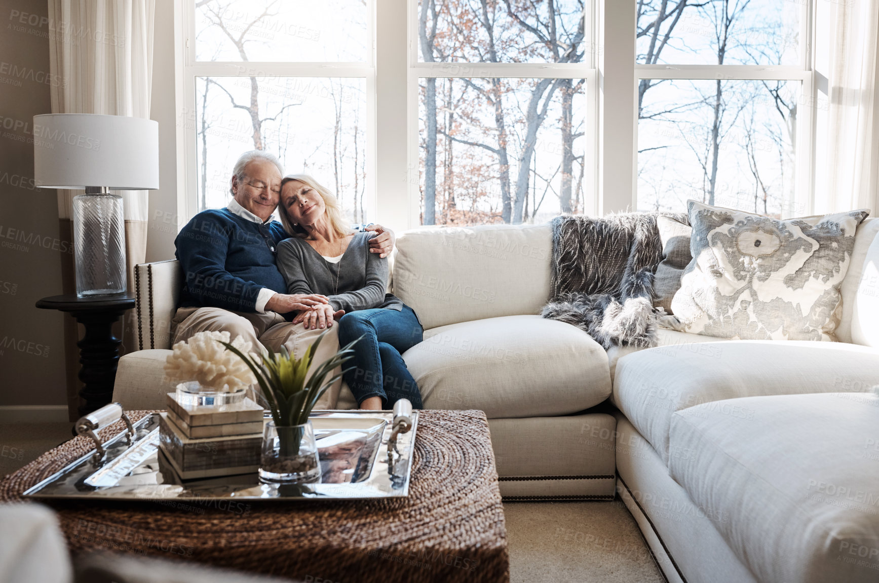 Buy stock photo Shot of a loving mature couple relaxing together at home