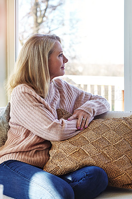 Buy stock photo Cropped shot of an attractive mature woman relaxing at home