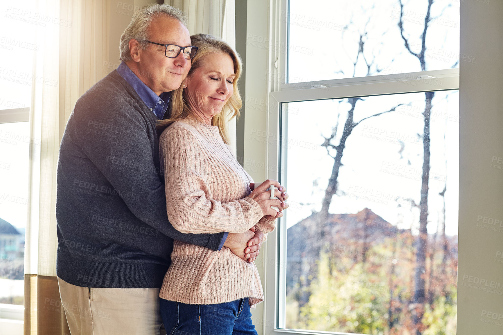 Buy stock photo Cropped shot of an affectionate senior married couple spending time together at home