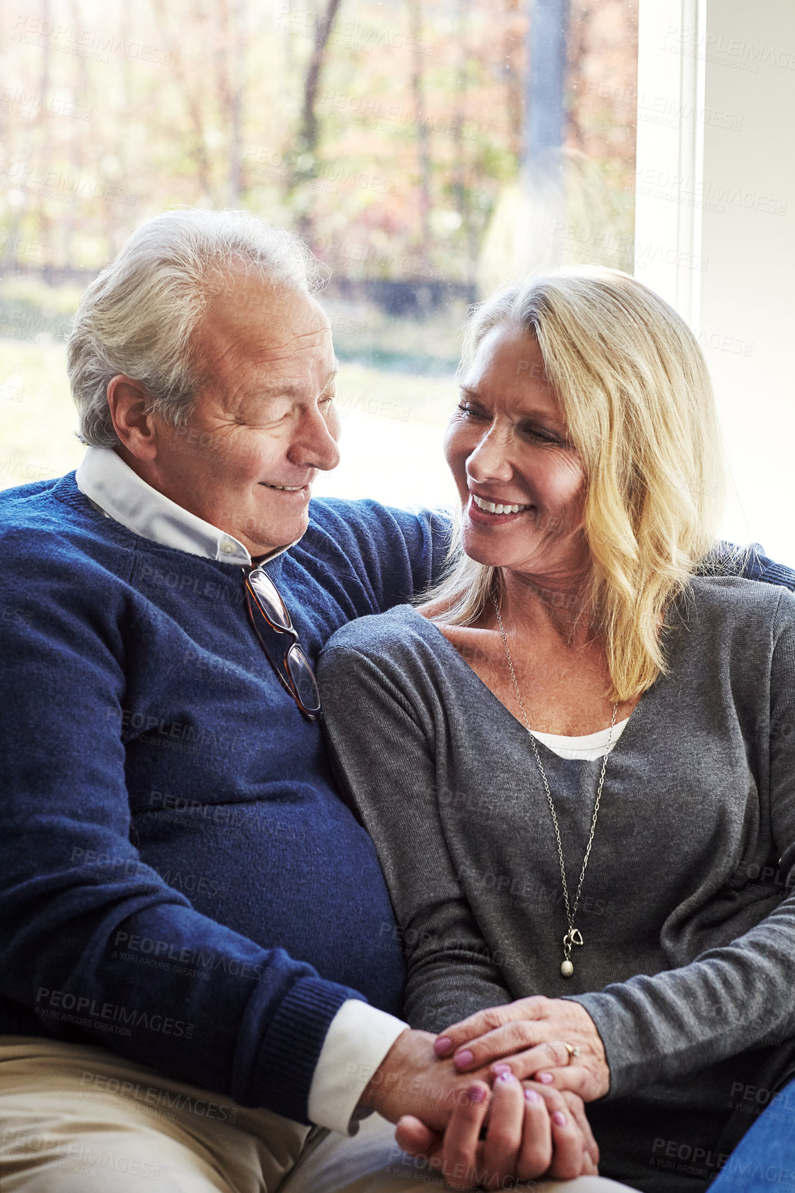 Buy stock photo Cropped shot of an affectionate senior married couple spending time together at home