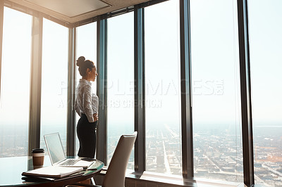 Buy stock photo Cropped shot of an attractive young businesswoman standing with her hands on her hips in the office