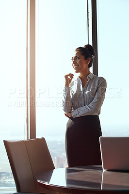 Buy stock photo Cropped shot of an attractive young businesswoman looking thoughtful while standing in her office