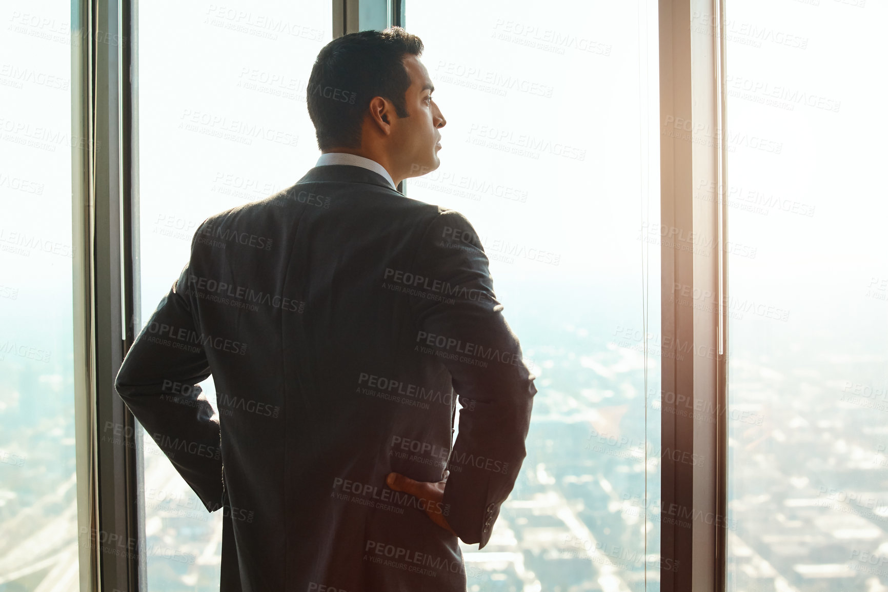 Buy stock photo Business man, office window and thinking of ideas, plan or vision with cityscape. Professional male executive with hands on hips for opportunity, dream and future corporate development from behind