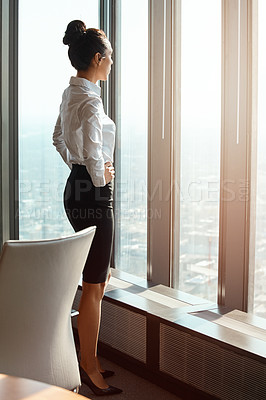Buy stock photo Cropped shot of an attractive young businesswoman standing with her hands on her hips in the office