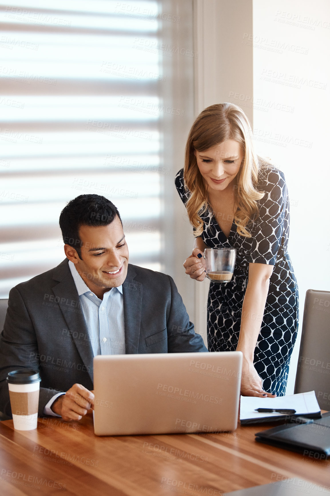 Buy stock photo Cropped shot of two young businesspeople working together in a modern office