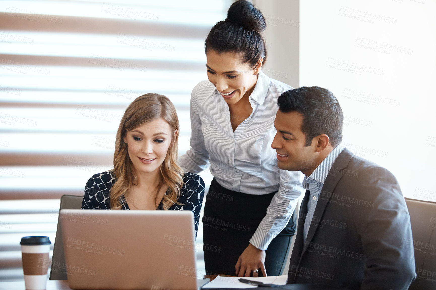 Buy stock photo Cropped shot of three young businesspeople working together in a modern office