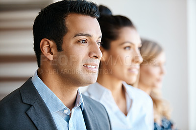 Buy stock photo Cropped shot of three young businesspeople standing in their office