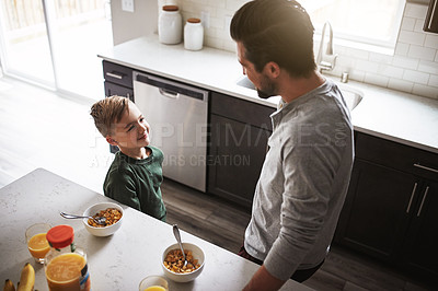 Buy stock photo Child, happy and breakfast in kitchen with dad for nutrition, wellness and development. Top view, family and smile for cereal and orange juice for vitamins, growth and together on weekend in home