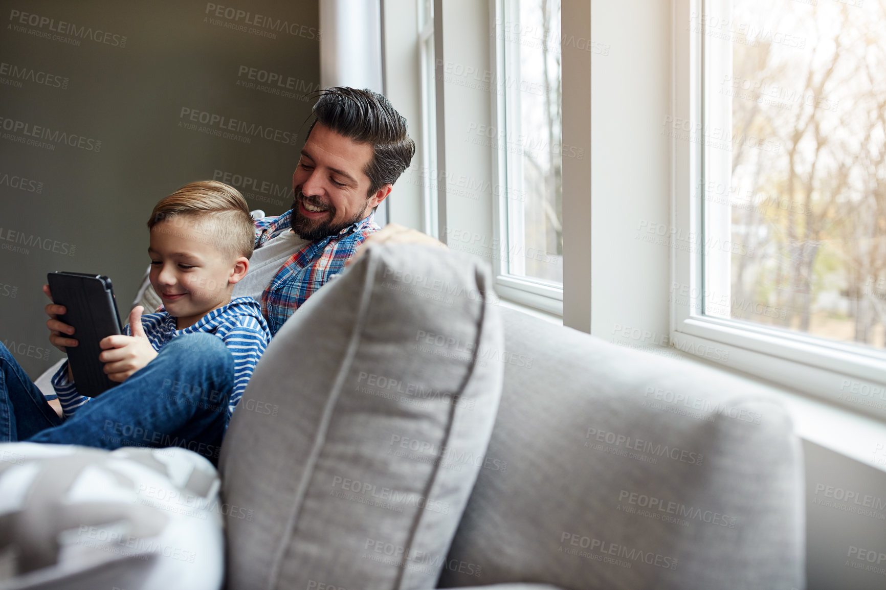 Buy stock photo Man, kid and tablet on sofa with internet for educational gaming, movie bonding and online tv show. Family, father and son with digital tech on couch in living room for relax, streaming and happy